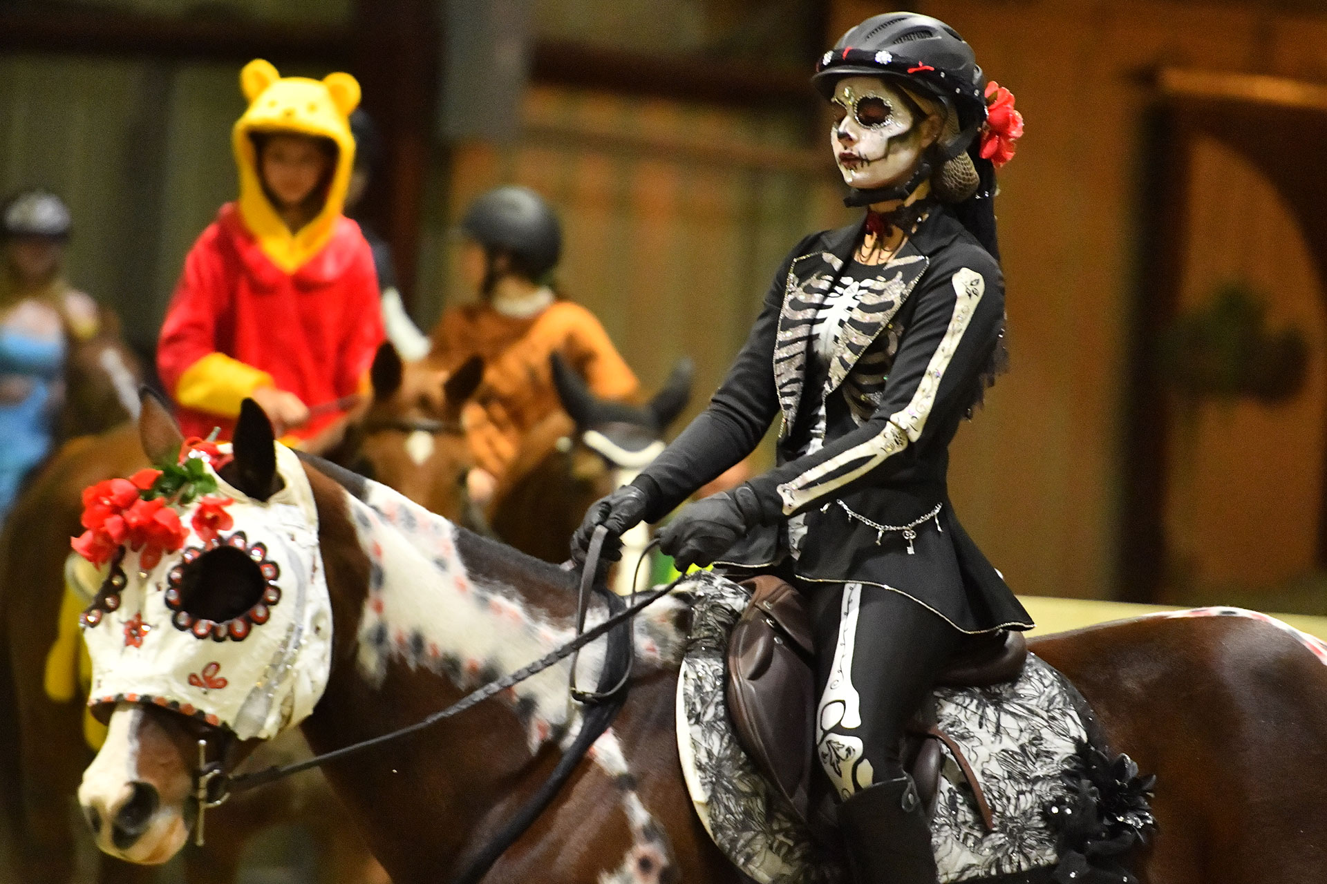 A rider in a Halloween costume competes at the MEC Halloween Spooktacular